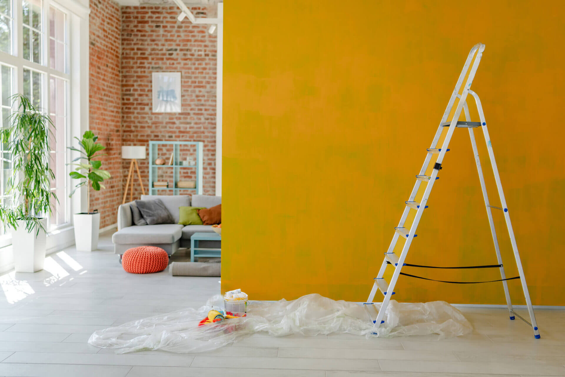 Ladder beside yellow wall in living room