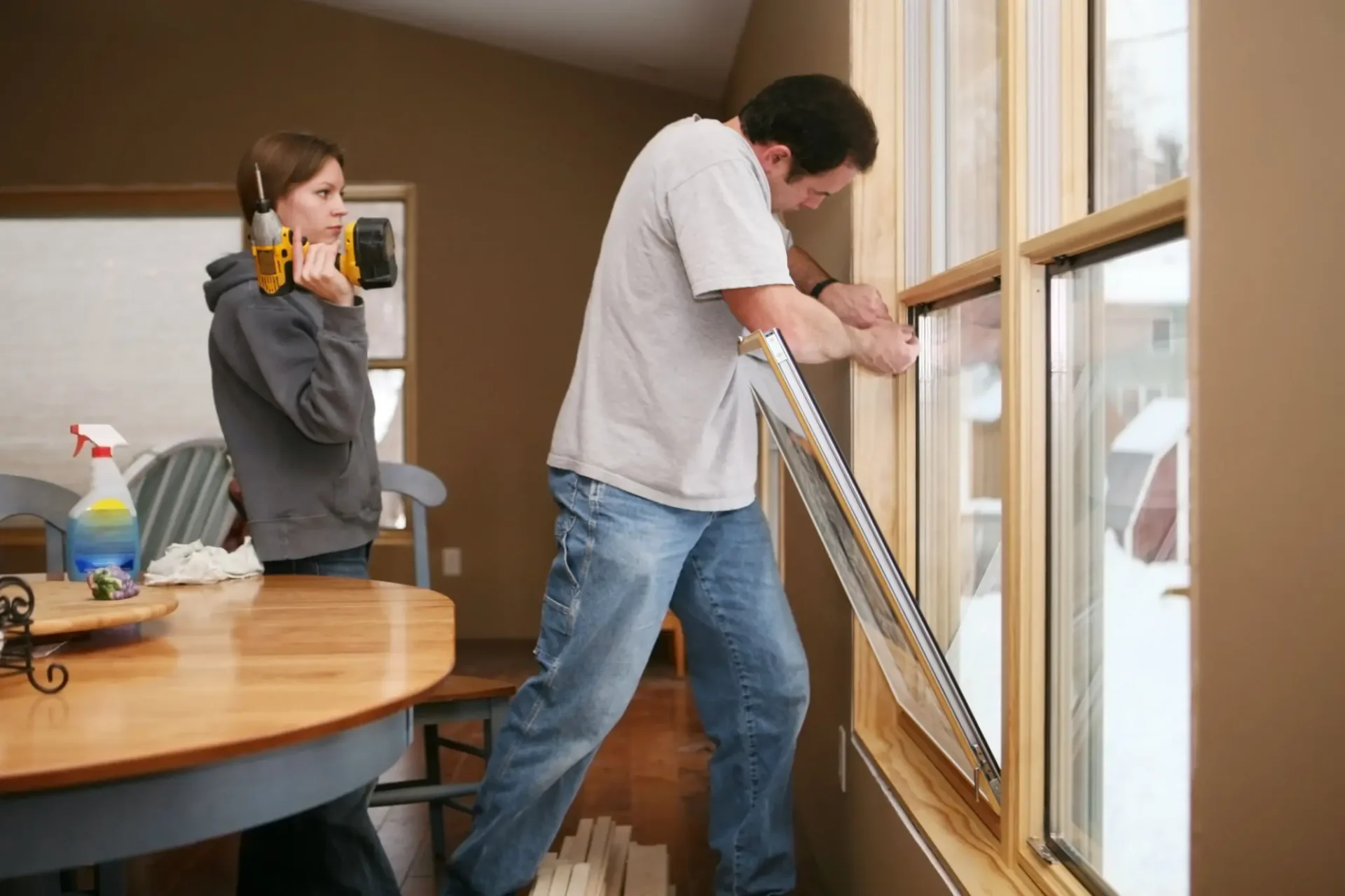 Home renovation: man installing window trim