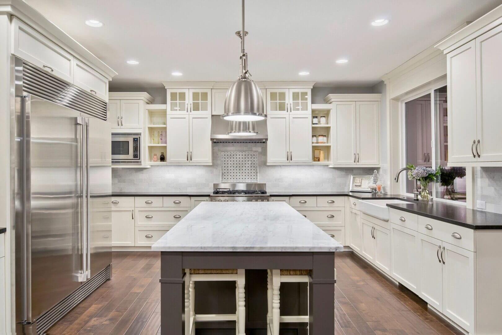 Bright white kitchen with marble island